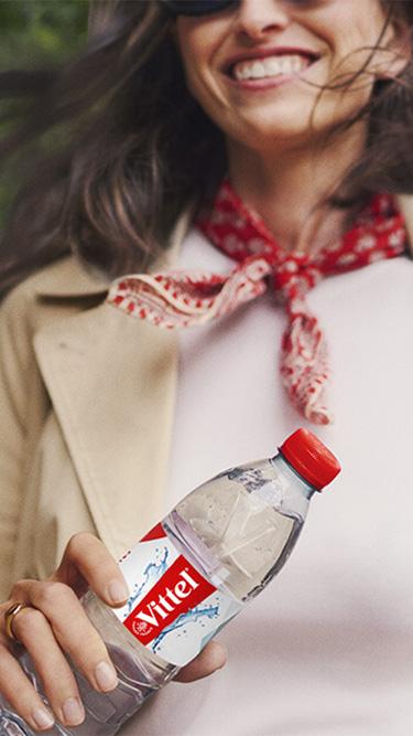 a woman with a VITTEL water bottle